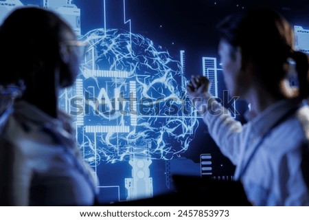 Computer scientists brainstorm ways to use AI cognitive computing to extract usable information from complex data. Data center employees implement artificial intelligence to process massive datasets