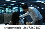 Computer scientists in data center managing and maintaining databases, ensuring data integrity and security. IT staff members updating server room systems using, camera A