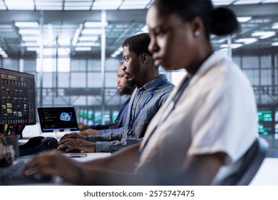 Computer scientists in data center using diagnostic tools and system monitoring software to identify errors. Team of IT specialists in server farm establishment repairing equipment
