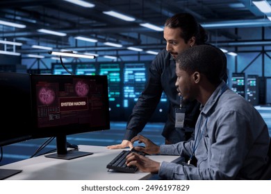 Computer scientists in server hub workspace frightened by hacker passing firewall and stealing data. Security breach notification on monitor in data center surprising IT specialists