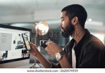 Computer screen, coffee and man on mobile in office on overtime at night in creative startup. Phone, drink beverage and employee reading ads, online business and website as social media marketer