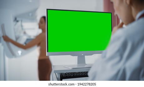 Computer Screen in Hospital Radiology Room: Beautiful Multiethnic Adult Woman Standing Topless Undergoing Mammography Screening Procedure. Screen Showing Green Mock-up Chroma Key Template. - Powered by Shutterstock