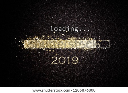 Computer screen with loading bar counting down for New Years Eve 2019 with sparkling glitter and copy space over black