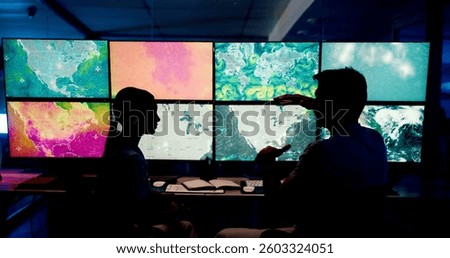 Computer, screen and maps with people in control room for storm tracking, satellite forecast or planning weather pattern. Back, meteorology team or radar data for climate monitor, silhouette or night