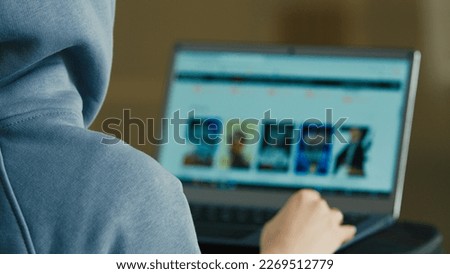 Computer screen view over shoulder unknown unrecognizable man back businessman engineer programmer hacker specialist search information online internet browser choose film tv movie on website laptop