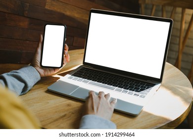 computer screen,cell phone blank mockup.hand woman work using laptop texting mobile.with white background for advertising,contact business search information on desk in cafe.marketing,design