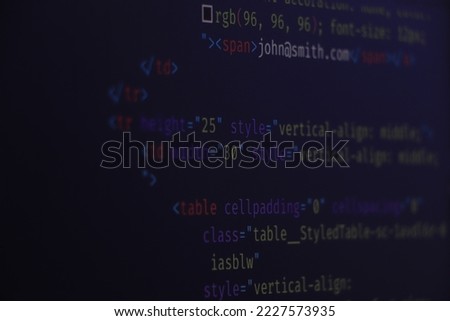 Computer script typing work. Programmer typing new lines of HTML code. Closeup of Java Script, CSS and HTML code. Coding hacker concept. Software source code.