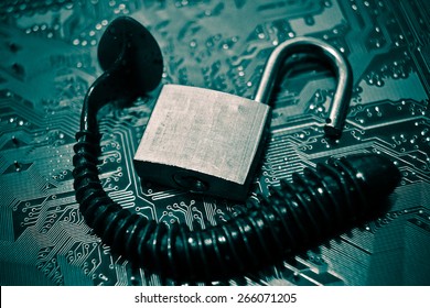 computer security breach due to worm attack - worm on computer circuit board with open security lock