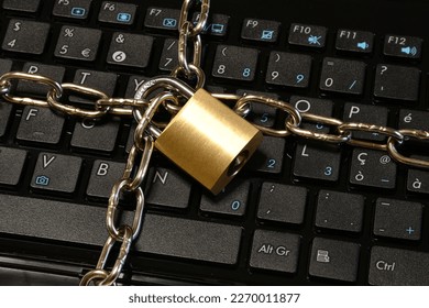 Computer security concept with a chain and padlock on the laptop keyboard