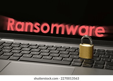 Computer security concept with a closed padlock on the laptop keyboard and "Ransomware" text on the screen. Cyber threat concept image.