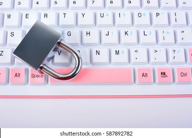Computer security concept with a closed padlock on the keyboard on white background