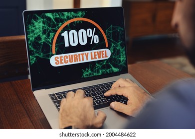 Computer security concept with hand on laptop computer
