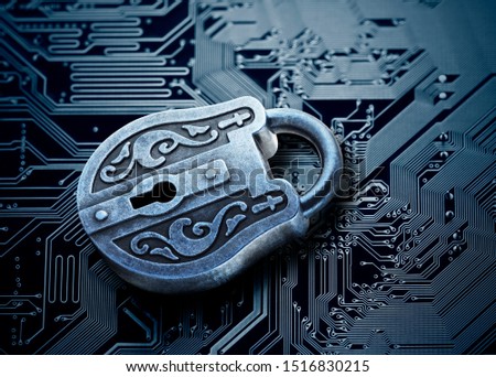 Computer security concept. Old mysterious padlock on computer circuit board