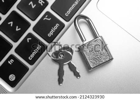 Computer security concept. Padlock on computer keyboard, laptop in office. Cyber security and privacy background