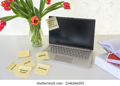 Computer security, laptop with various sticky password notes on a white desk, concept for safety in home office, business or study, copy space, selected focus, narrow depth of field