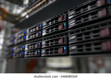 Computer Server mount on rack in data center room with red lighting alarm.