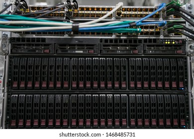 Computer Server mount on rack in data center room with red lighting alarm.