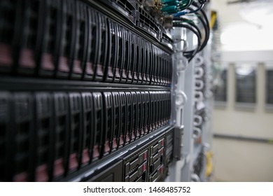 Computer Server mount on rack in data center room with red lighting alarm.
