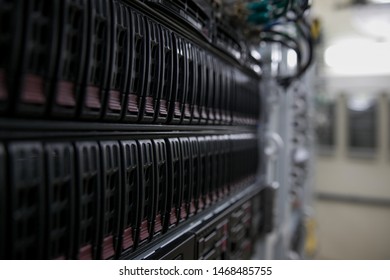 Computer Server mount on rack in data center room with red lighting alarm.