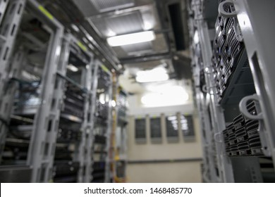 Computer Server mount on rack in data center room with red lighting alarm.