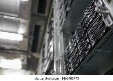 Computer Server mount on rack in data center room with red lighting alarm.