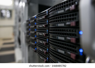 Computer Server mount on rack in data center room with red lighting alarm. - Powered by Shutterstock - Get 15% off with code: PIKWIZARD15