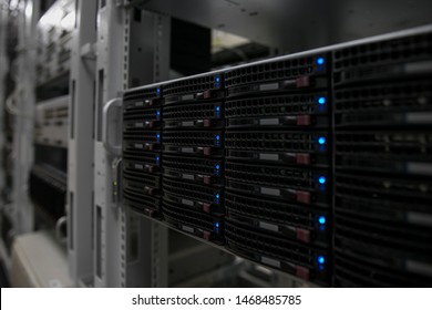 Computer Server mount on rack in data center room with red lighting alarm.