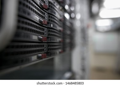 Computer Server mount on rack in data center room with red lighting alarm.