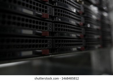 Computer Server mount on rack in data center room with red lighting alarm.