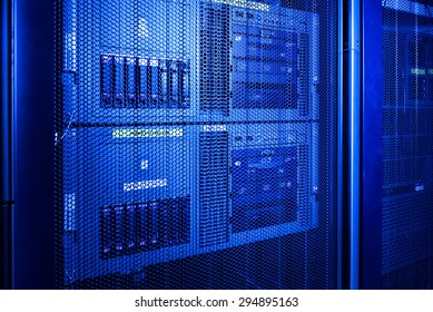 Computer Server in rack server close-up with blue light - Powered by Shutterstock - Get 15% off with code: PIKWIZARD15