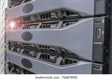 The computer server is in the rack in the server room of the data center. Red alarm indication is on the powerful Internet equipment. The database is on hard disks of computer servers