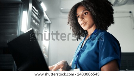 Computer, server room and woman programming software, update or system network maintenance. Technology, data center or technician on laptop for information, cyber security or code for cloud computing