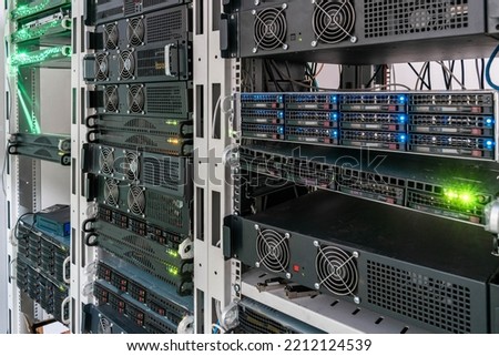 Computer servers run in data center racks. Powerful computing equipment is located on the hosting site.