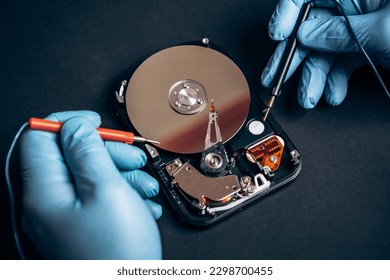 Computer service engineer technician workplace repairing fixing disassembled HDD hard drive data disc SSD, using multimeter ammeter. Recovery, maintenance work, access file. Profession repairman

