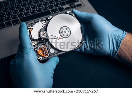 Computer service engineer technician workplace repairing fixing disassembled HDD hard drive data disc SSD, backup part of PC or laptop. Recovery, maintenance work, access file. Profession repairman

