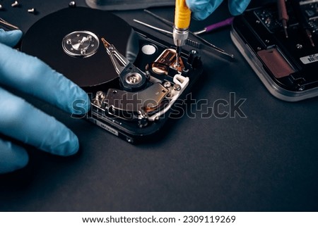 Computer service engineer technician workplace repairing fixing disassembled HDD hard drive data disc SSD, backup part of PC or laptop. Recovery, maintenance work, access file. Profession repairman

