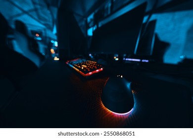 Computer setup featuring a colorful keyboard and mouse in a dimly lit room - Powered by Shutterstock - Get 15% off with code: PIKWIZARD15
