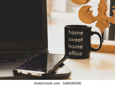 Computer With Smartphone On Work Desk With Focus On Coffee Cup With Phrase 