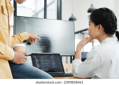 IT computer software developer team, programmer, software engineer and software analysis working on computer sourcecode project. Team of developers cooperating while working on desktop PC.