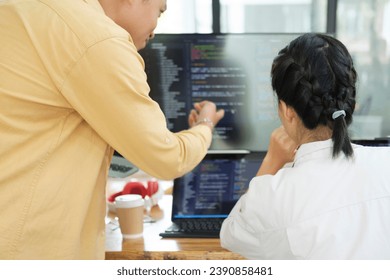 IT computer software developer team, programmer, software engineer and software analysis working on computer sourcecode project. Team of developers cooperating while working on desktop PC.