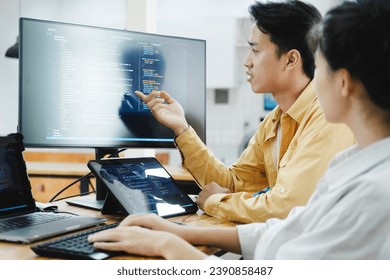 IT computer software developer team, programmer, software engineer and software analysis working on computer sourcecode project. Team of developers cooperating while working on desktop PC.