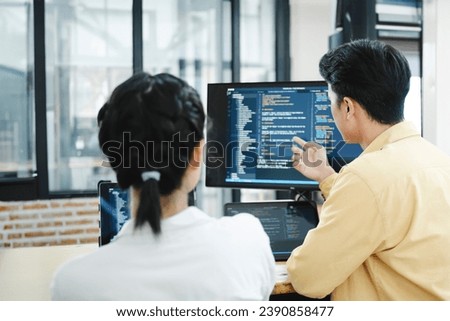 IT computer software developer team, programmer, software engineer and software analysis working on computer sourcecode project. Team of developers cooperating while working on desktop PC.