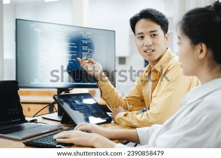 IT computer software developer team, programmer, software engineer and software analysis working on computer sourcecode project. Team of developers cooperating while working on desktop PC.