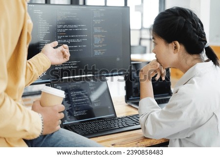 IT computer software developer team, programmer, software engineer and software analysis working on computer sourcecode project. Team of developers cooperating while working on desktop PC.