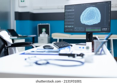 Computer Standing On Table Having Brain Radiography On Screen During Oncology Examination. Empty Hospital Office Equipped With Medical Professional Instruments. Health Care Services Support