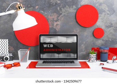 Computer staying on a table & showing the screen. Trendy & vibrant design. Geometry. Innovational digital internet applications & web business solutions. Modern workspace in an office. Development.