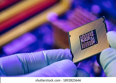 Computer support engineer installing processor. Microprocessor with clearly visible silicon core and cache chip. Installation of computer processor in the socket. - Shutterstock ID 1892823646