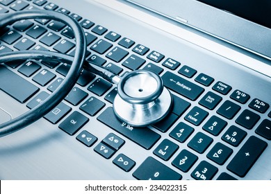 Computer System Health Or Auditing - Stethoscope Over A Computer Keyboard Toned In Blue