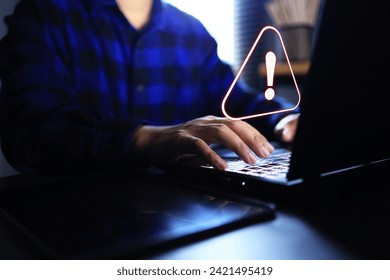 Computer system warning alert information data risk to stolen by hackers and virus attacked with programer working in office with laptop computer on desktop