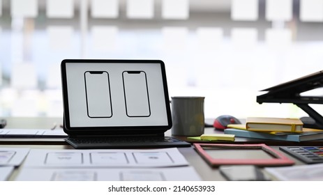 Computer tablet with wireframe sketch layout design on screen. User experience concept.